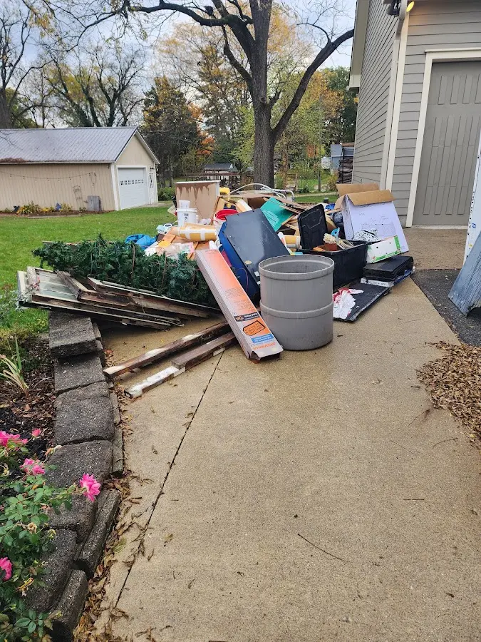 Dumpster being loaded with debris for Commercial Dumpster Rental in Durant